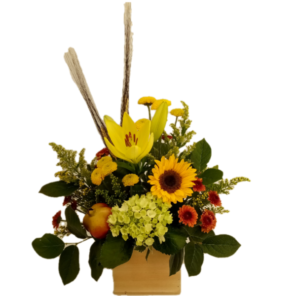 Bouquet of yellow and orange flowers accented with wheat stems and faux fruit arranged in a natural wood box.