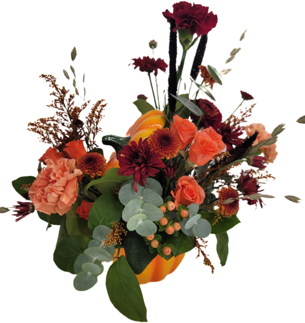 Fall flowers arranged in a ceramic pumpkin. Perfect for Autumn celebrations.