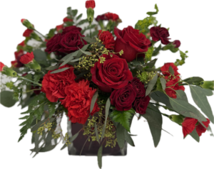 Elegant red floral arrangement with red roses in red cube