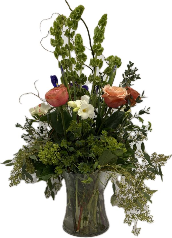 Tall vase arrangement featuring Bells of Ireland, Roses, Freesia, hydrangea, and Iris